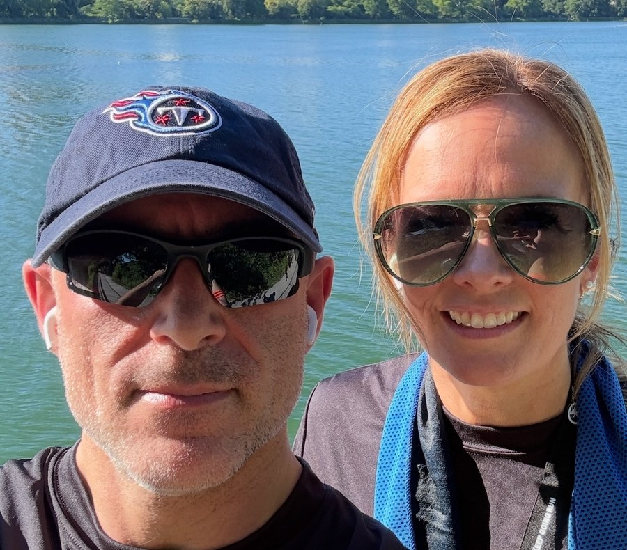 David and his wife at the Central Park reservoir, with the Manhattan skyline behind them