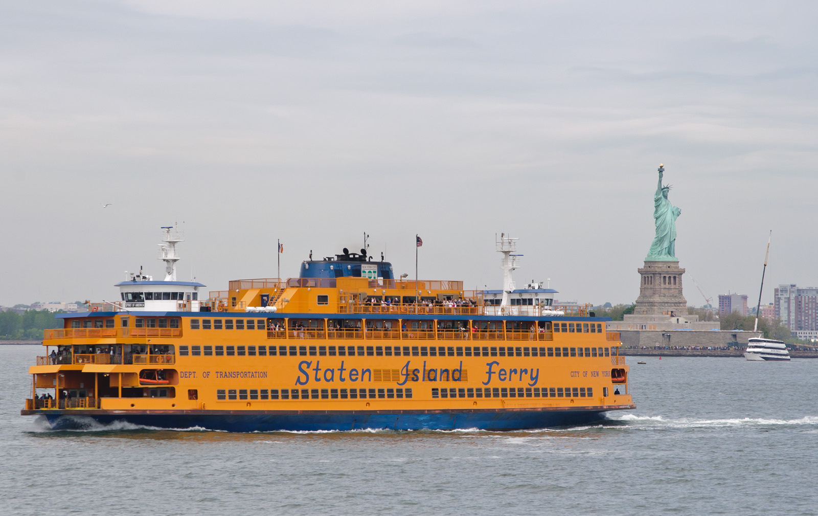 The orange Staten Island Ferry crossing New York Harbor
