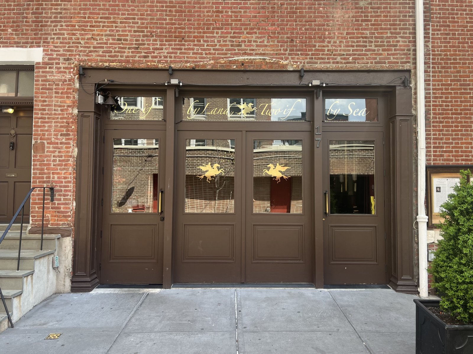 The candlelit entrance of One if by Land, Two if by Sea in a former carriage house